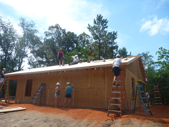 Volunteers working on house 