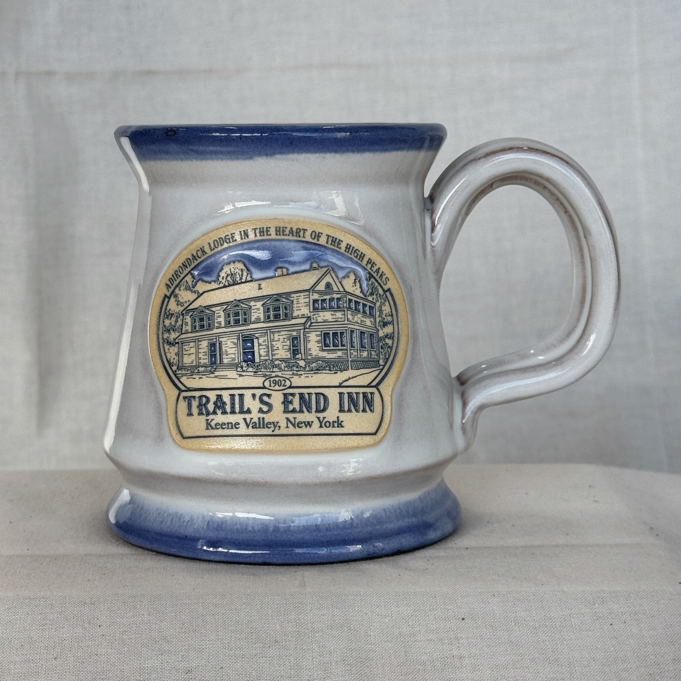 Gloss with blue trim footed mug 